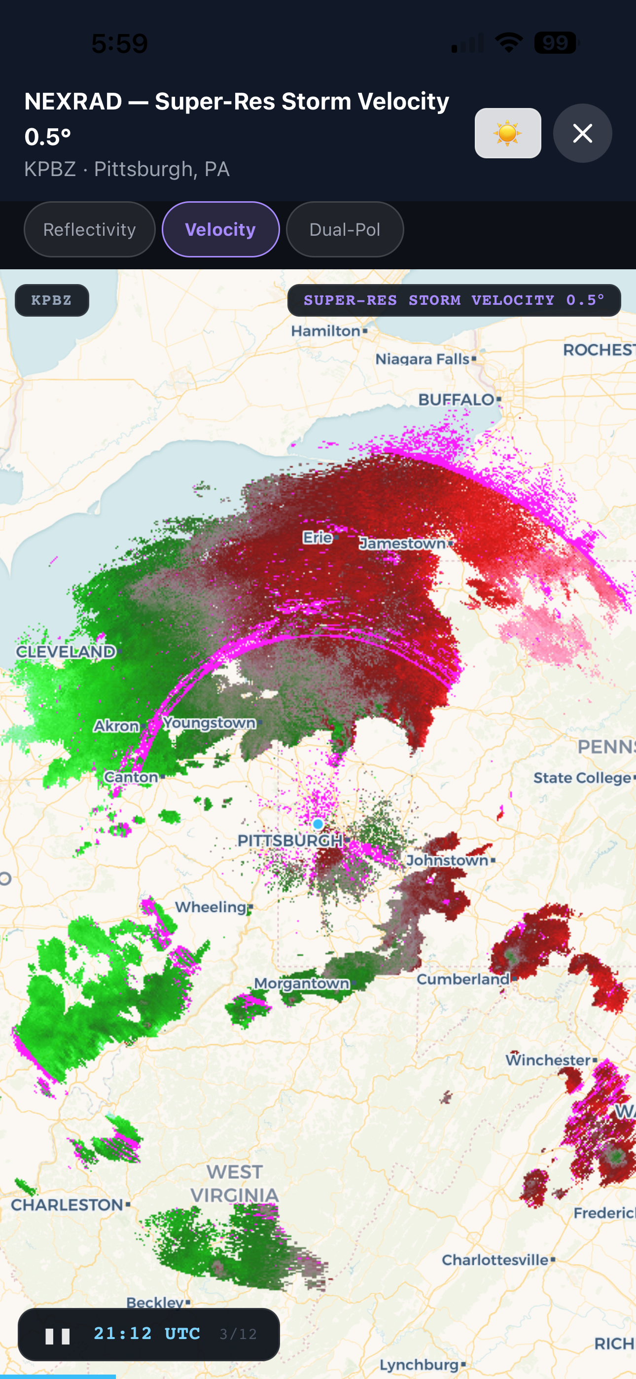 Full-screen NEXRAD velocity radar with pink and green storm relative motion data